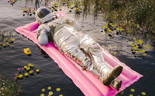 Astronaut laying on a pink float