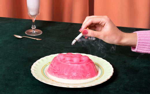 Stubbing out a cigarette on a plate of jelly
